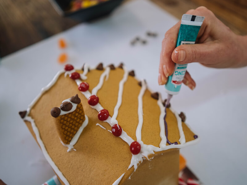 Hand icing gingerbread house